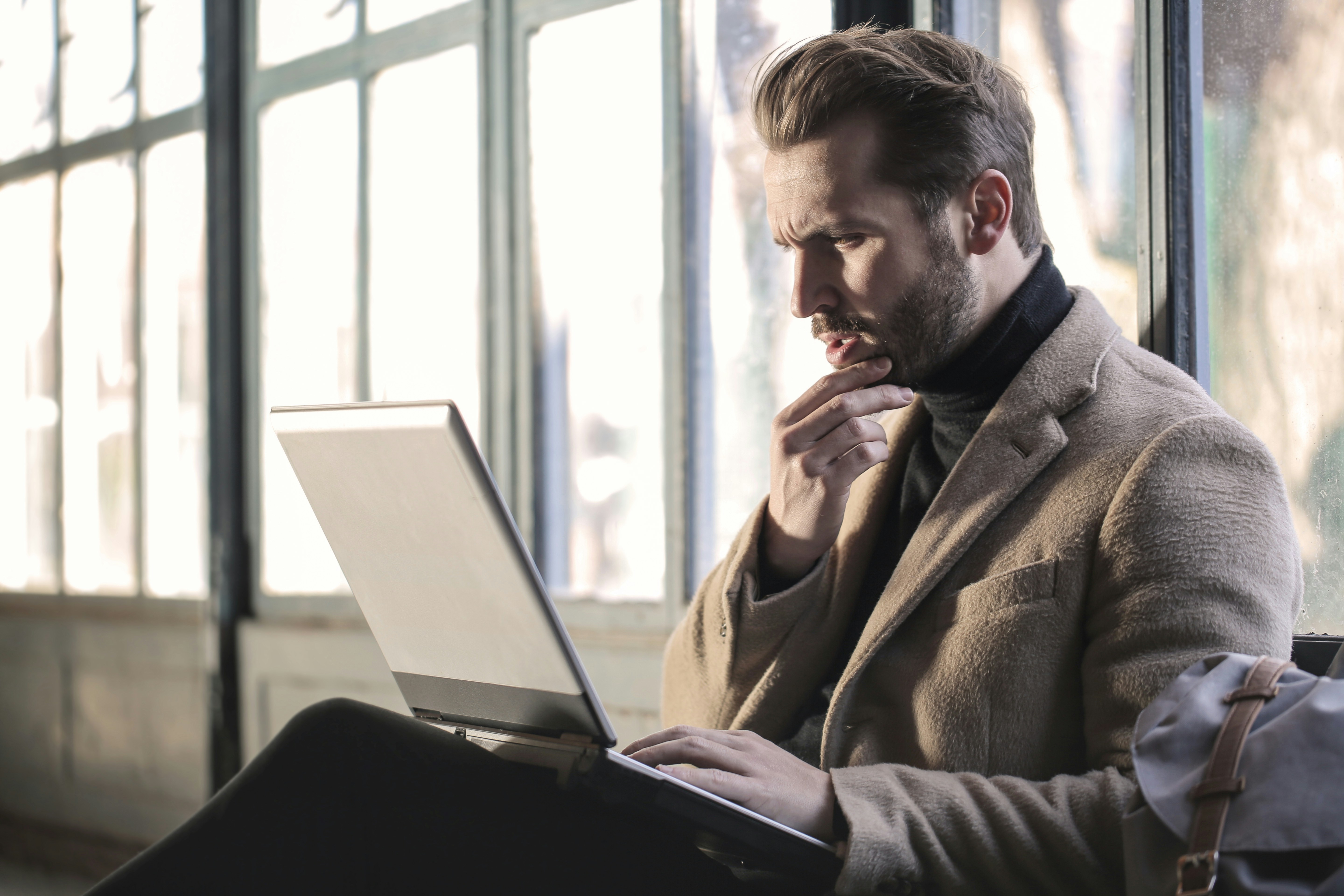 man working on laptop -Email Testing Tools