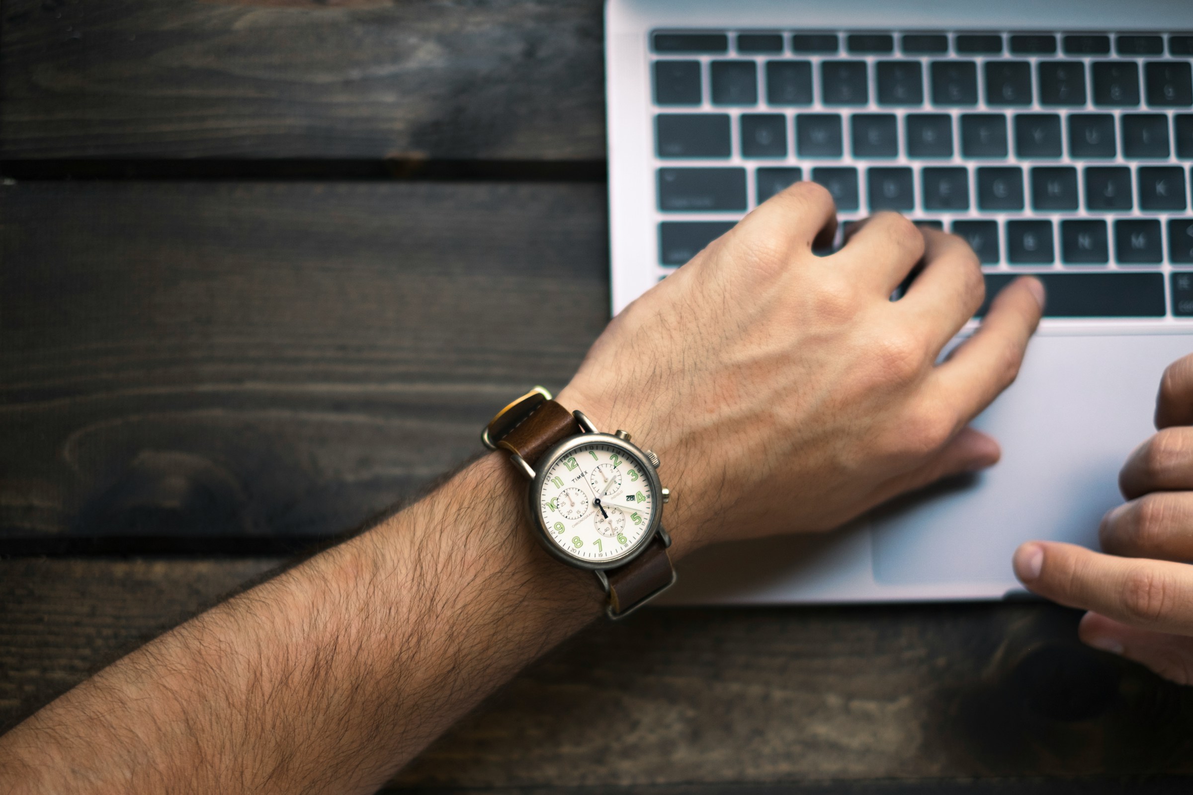 person looking at his watch - Best Time To Send Cold Emails