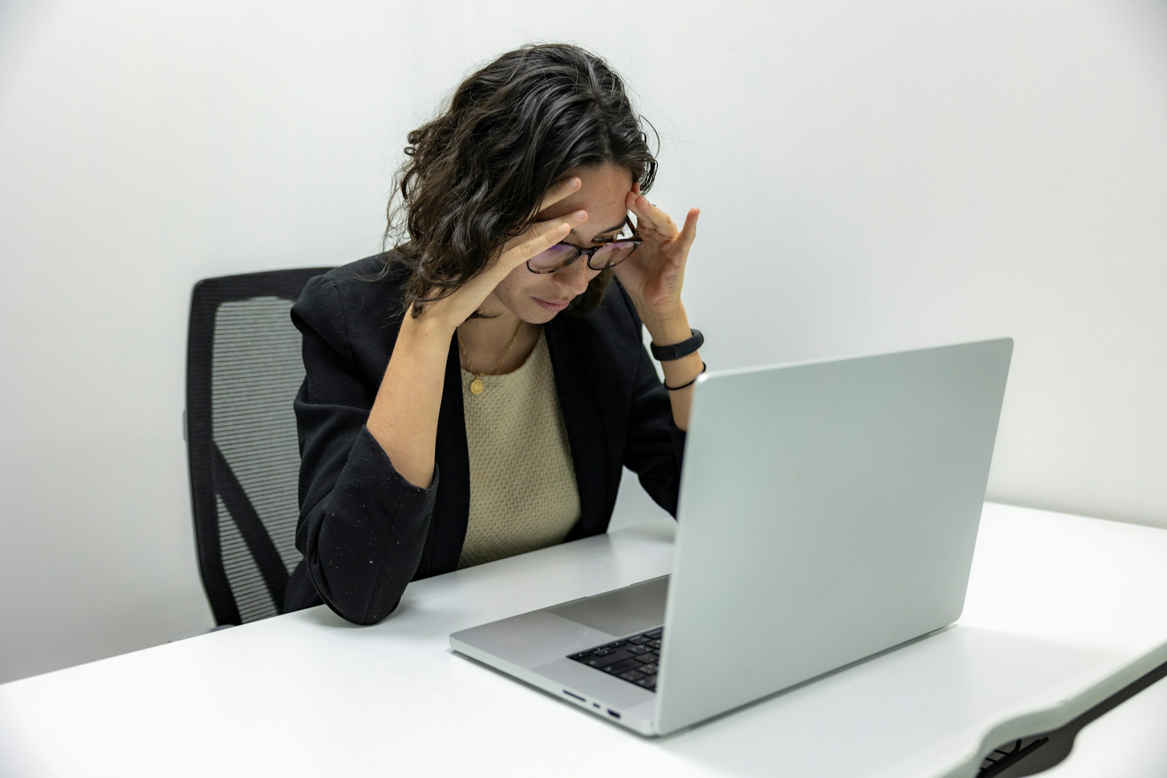 woman worried on laptop - Why Are My Emails Going to Spam